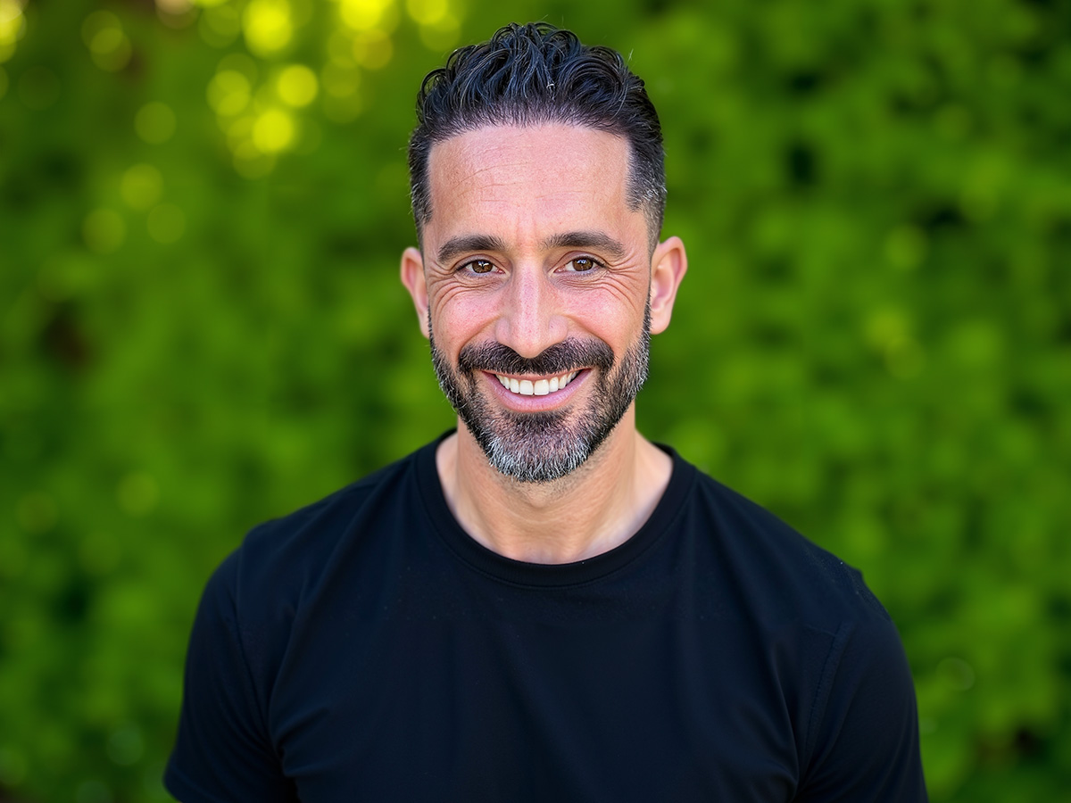 Portrait of Nick Statman against a green background.